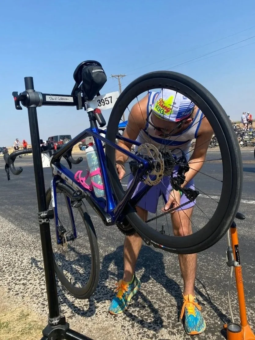 Austin working on a bicycle in a repair stand